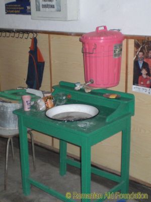 Washing Facilities at Balinti Kindergarten
This jury-rigged bin and tap were finally replaced in early 2017 after the caretaker forgot to empty it during one particularly cold winter night and the bin burst.  The basin and stand continue in service.
Keywords: May03;Schools;School-Balinti