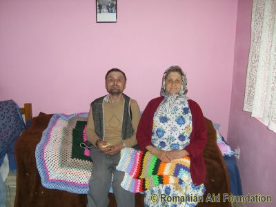 Viorel and Elena
Elena Cazaciuc shares a small house with her son, Viorel.  They appreciate the knitted blankets that they have received.
Keywords: May10;Fam-Horlaceni;
