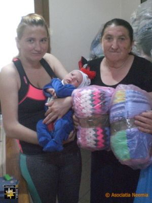 New Baby, New Babywear
Florentina and her mother Steluta received 'baby bags' containing knitwear, blankets and other items for caring for a new-born.
Keywords: jun19;Knits