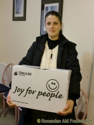 Raluca receives a gift box from Dorcas Aid.
Keywords: Mar12;Dorcas